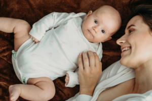 Pregnancy and Postpartum, Portrait of Mother and Newborn Baby, Mother Roasting